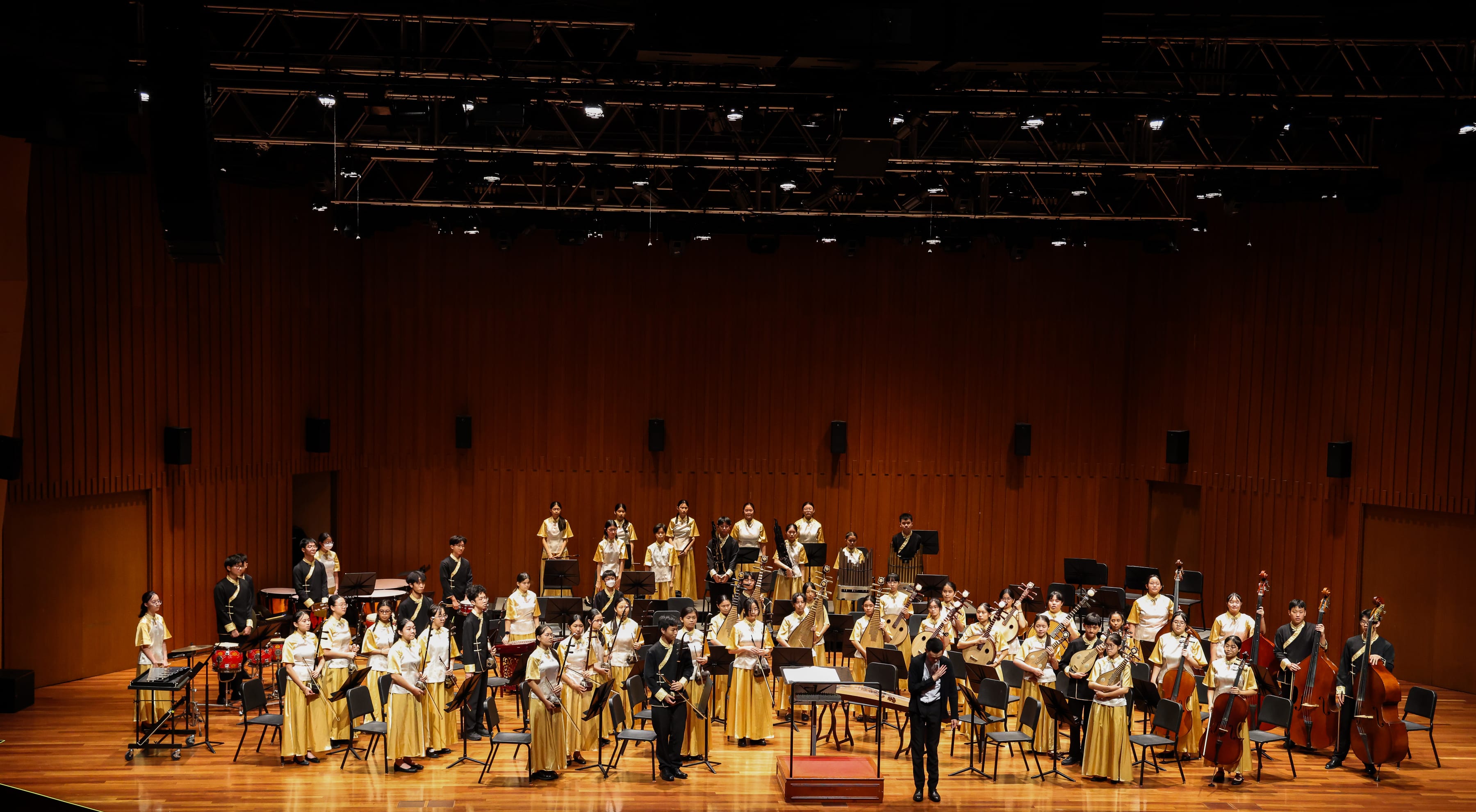 A wide shot of all CO members standing on stage after their SYF 2025 performance as the conductor bowed to the audience.